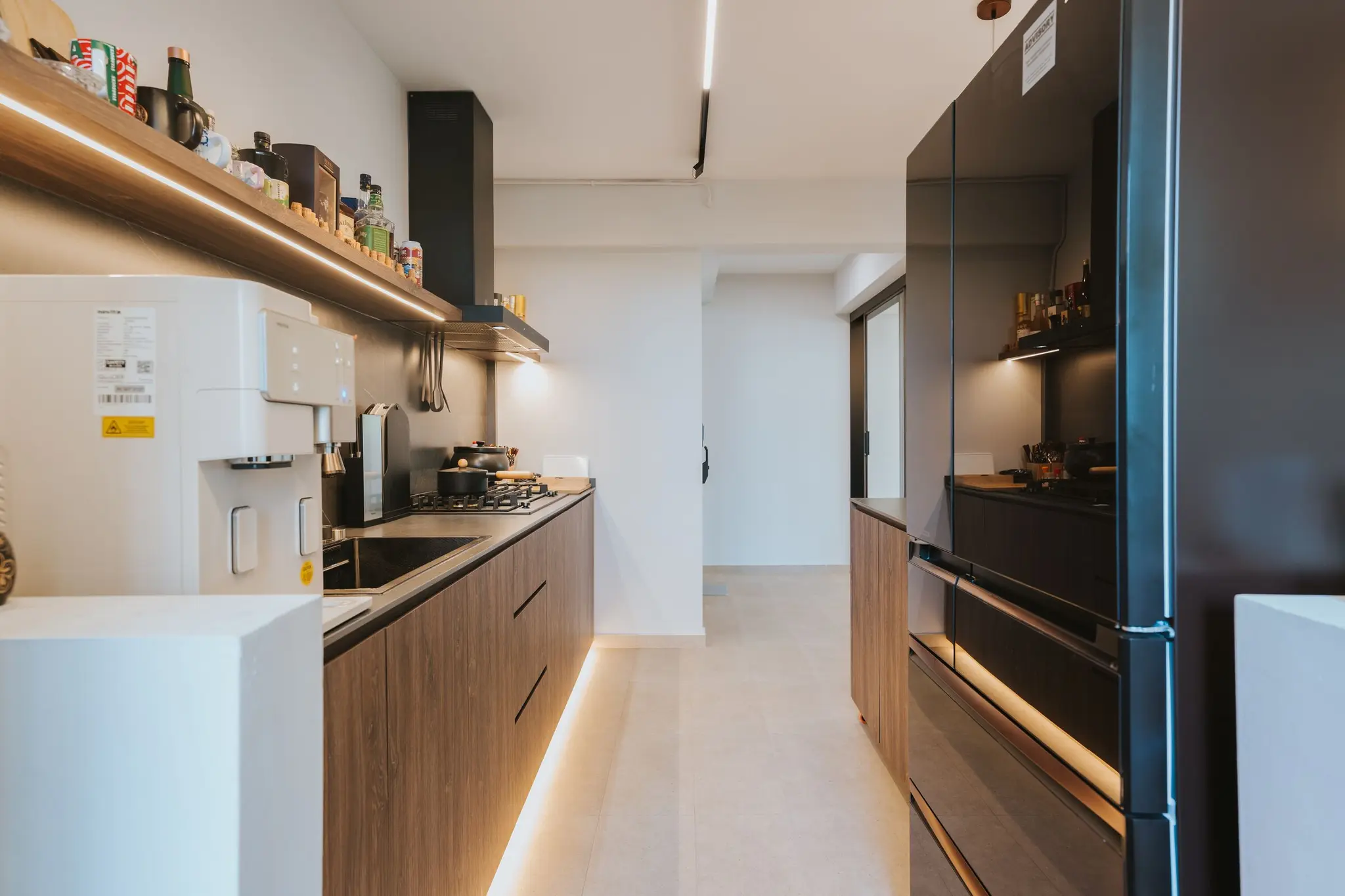Warm wood kitchen with dark stone surfaces at 213C Punggol Walk