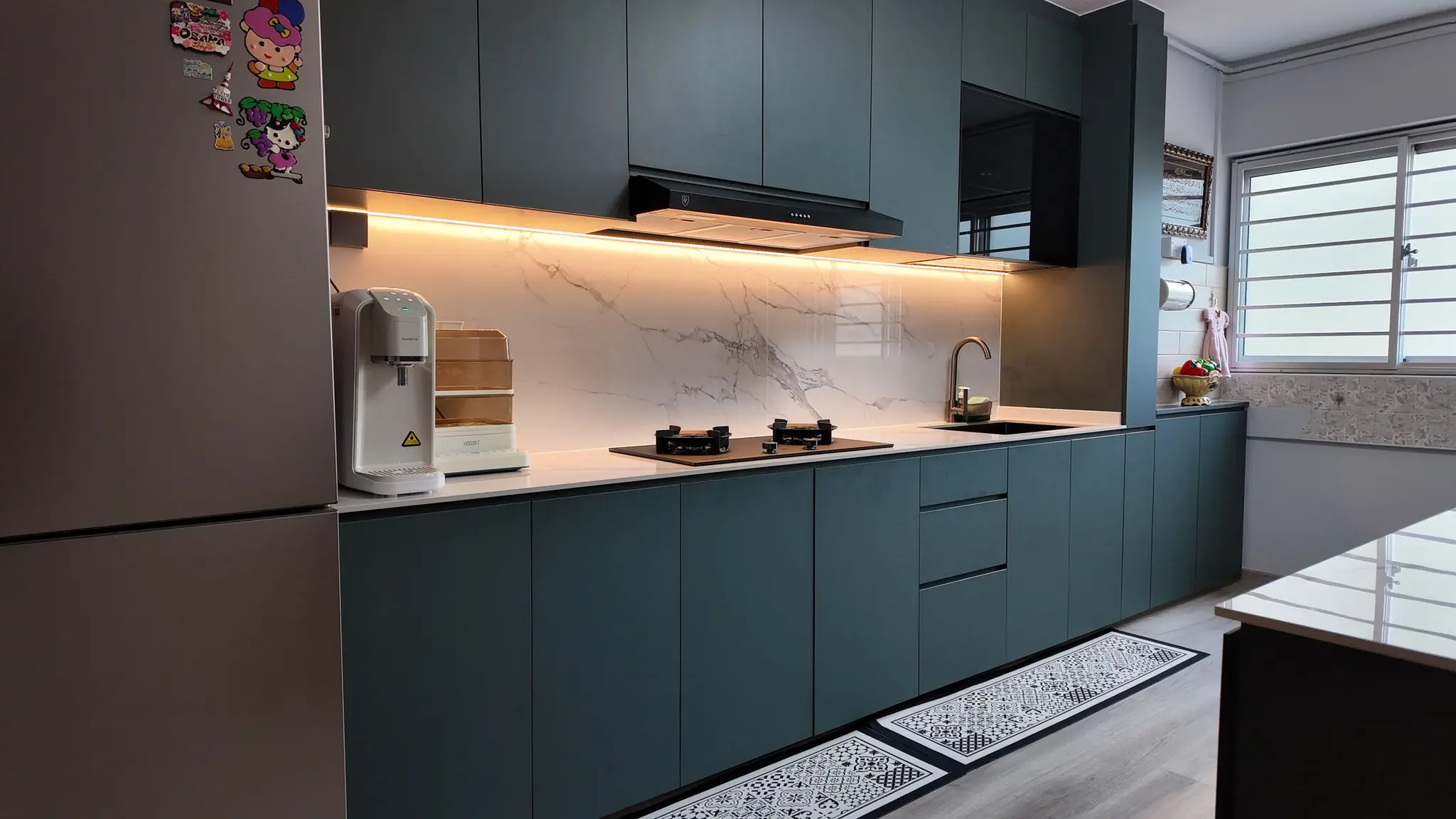 Green kitchen cabinetry with a marble-look backsplash at 337 Bukit Batok