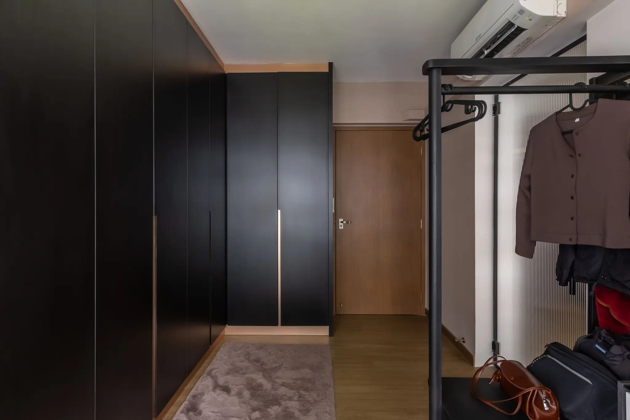 Walk-in wardrobe with open clothing rails at 401A North Shore
