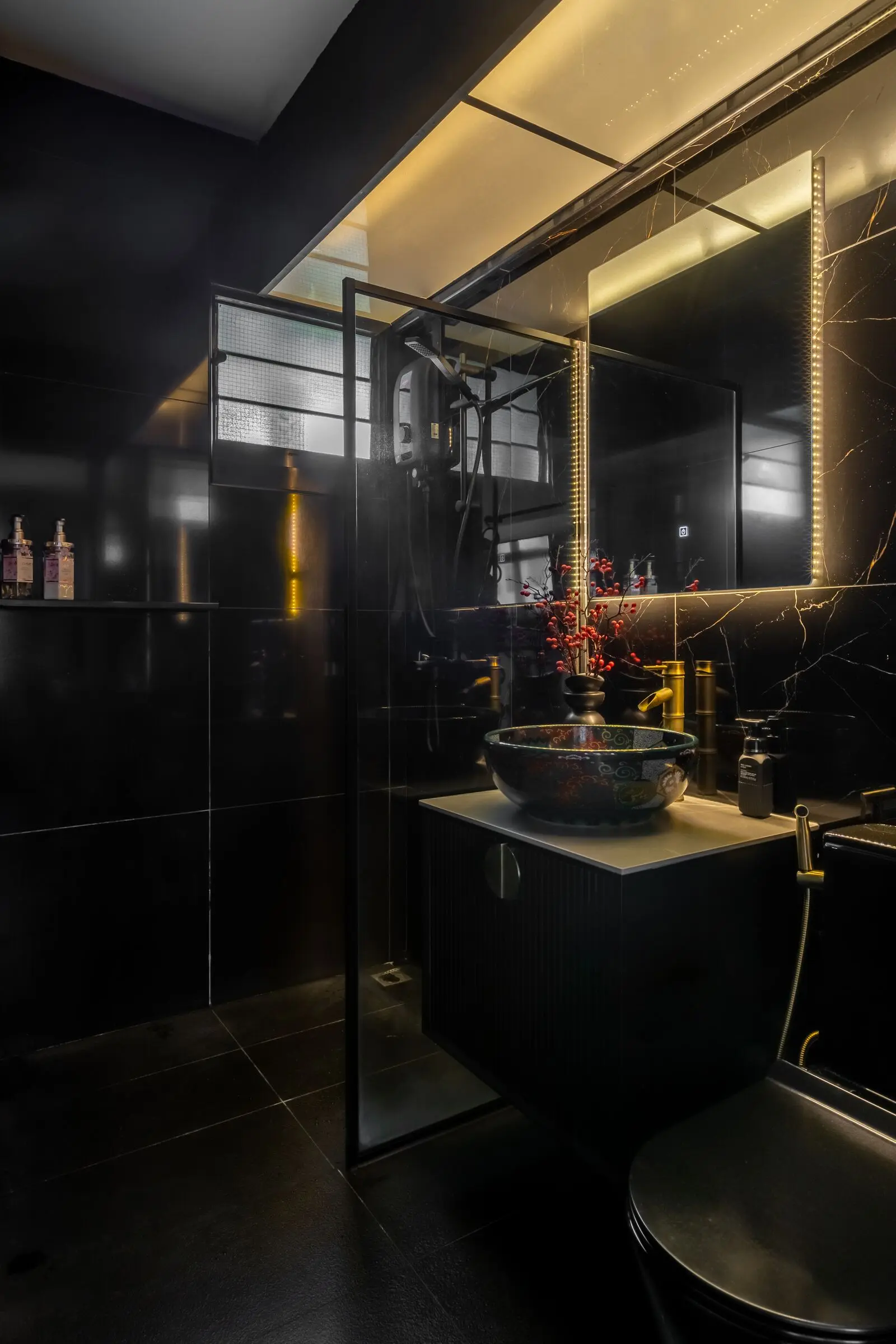 Dark bathroom vanity with illuminated mirror at 401A North Shore