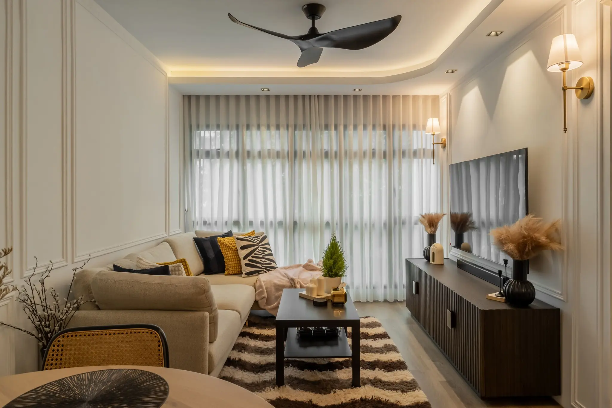 Living room with wall moulding and TV console at 405A Fernvale Lane