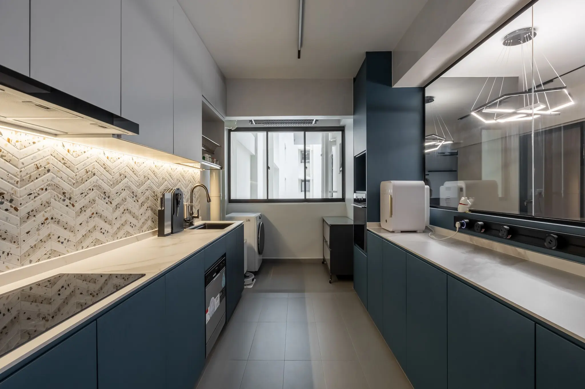 Galley kitchen with blue cabinetry at 447A Punggol Way