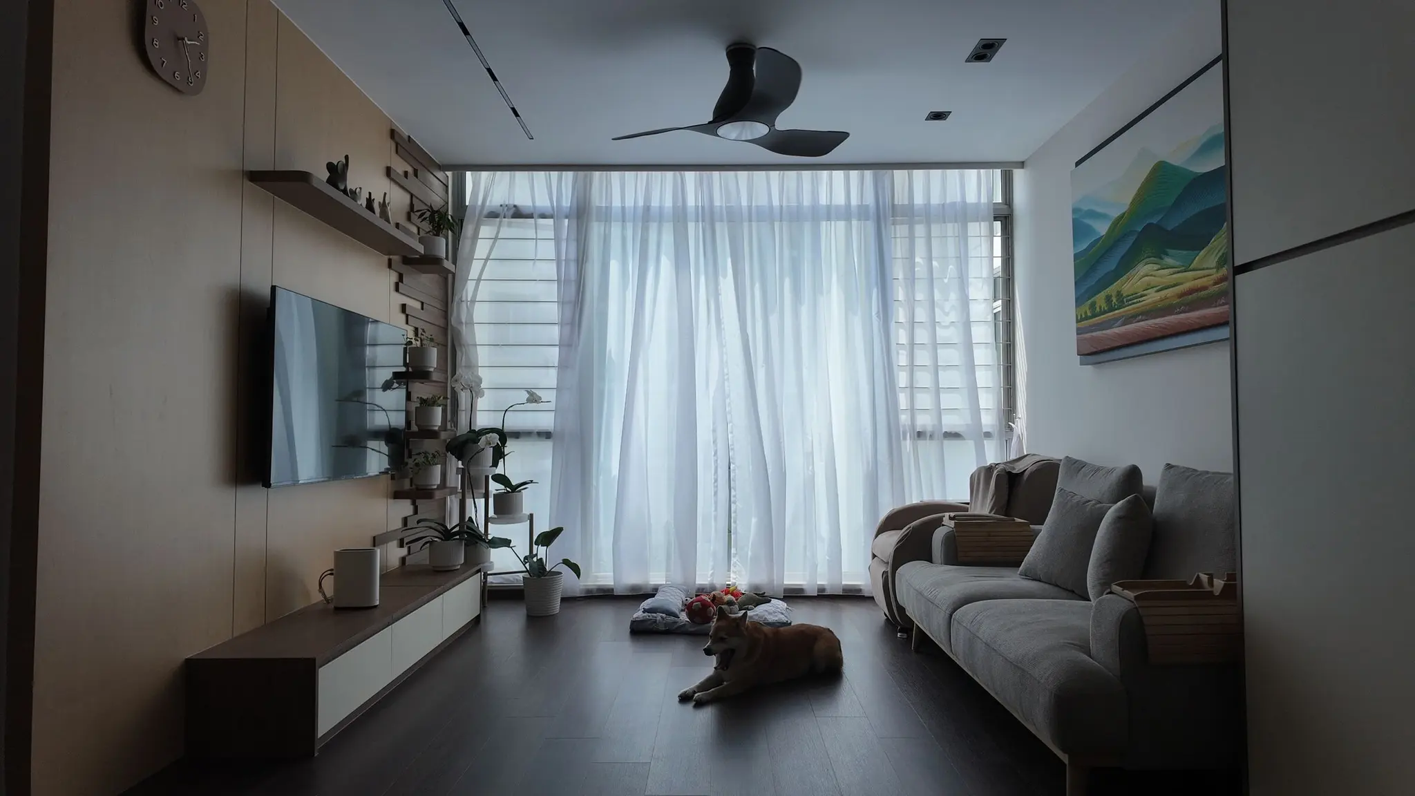 Living room with TV console and full-height windows at Lakeshore